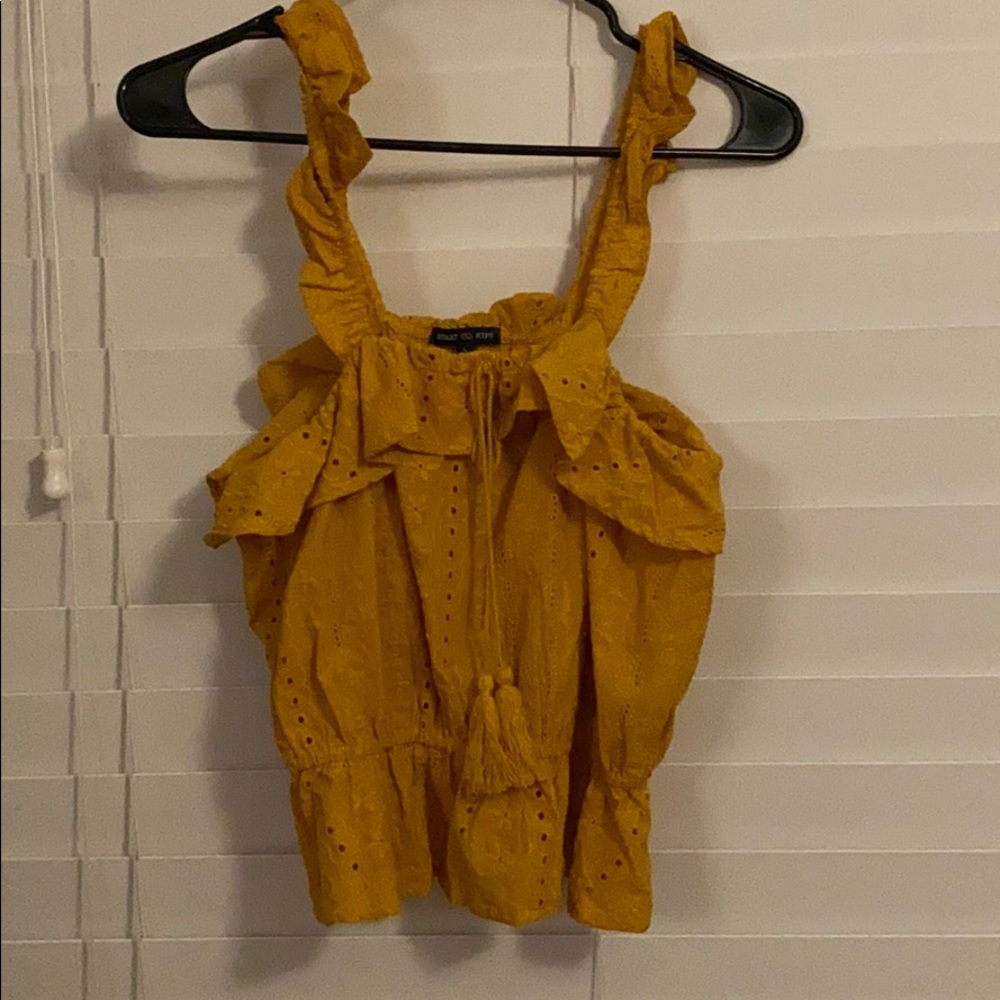 Mustard yellow shirt.